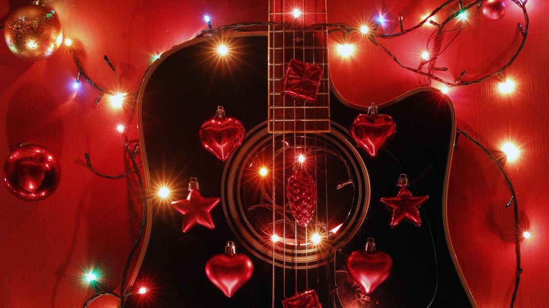 guitar strung with lights and ornaments