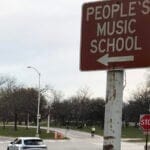 A street sign pointing towards The People's Music School