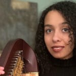 Miriam Kessler poses with a harp