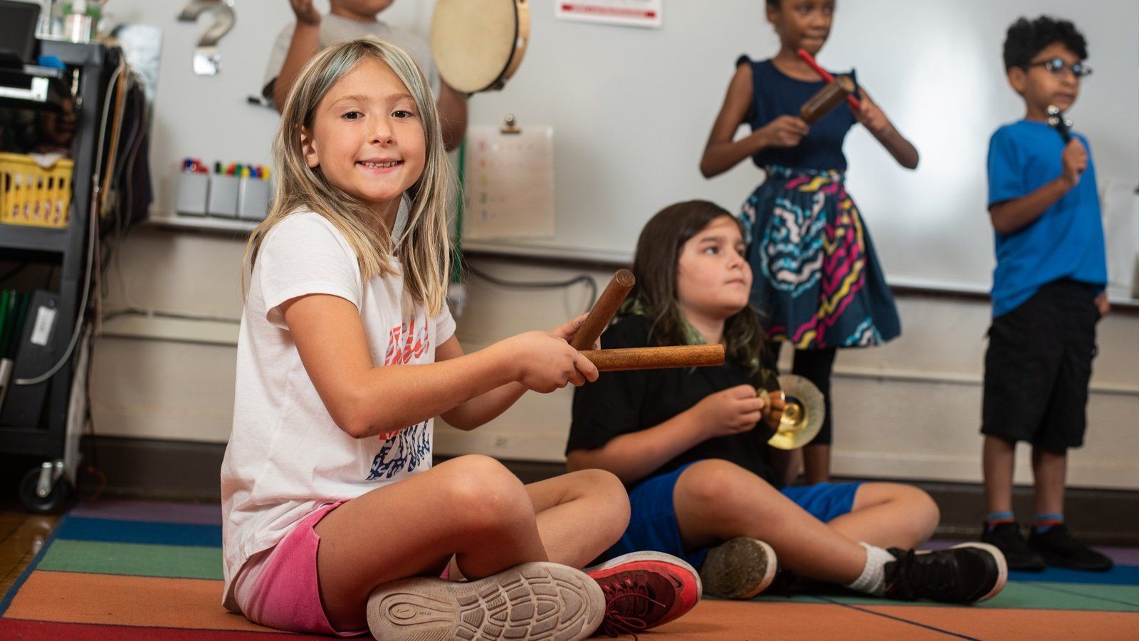 Kids learning to play percussion instruments