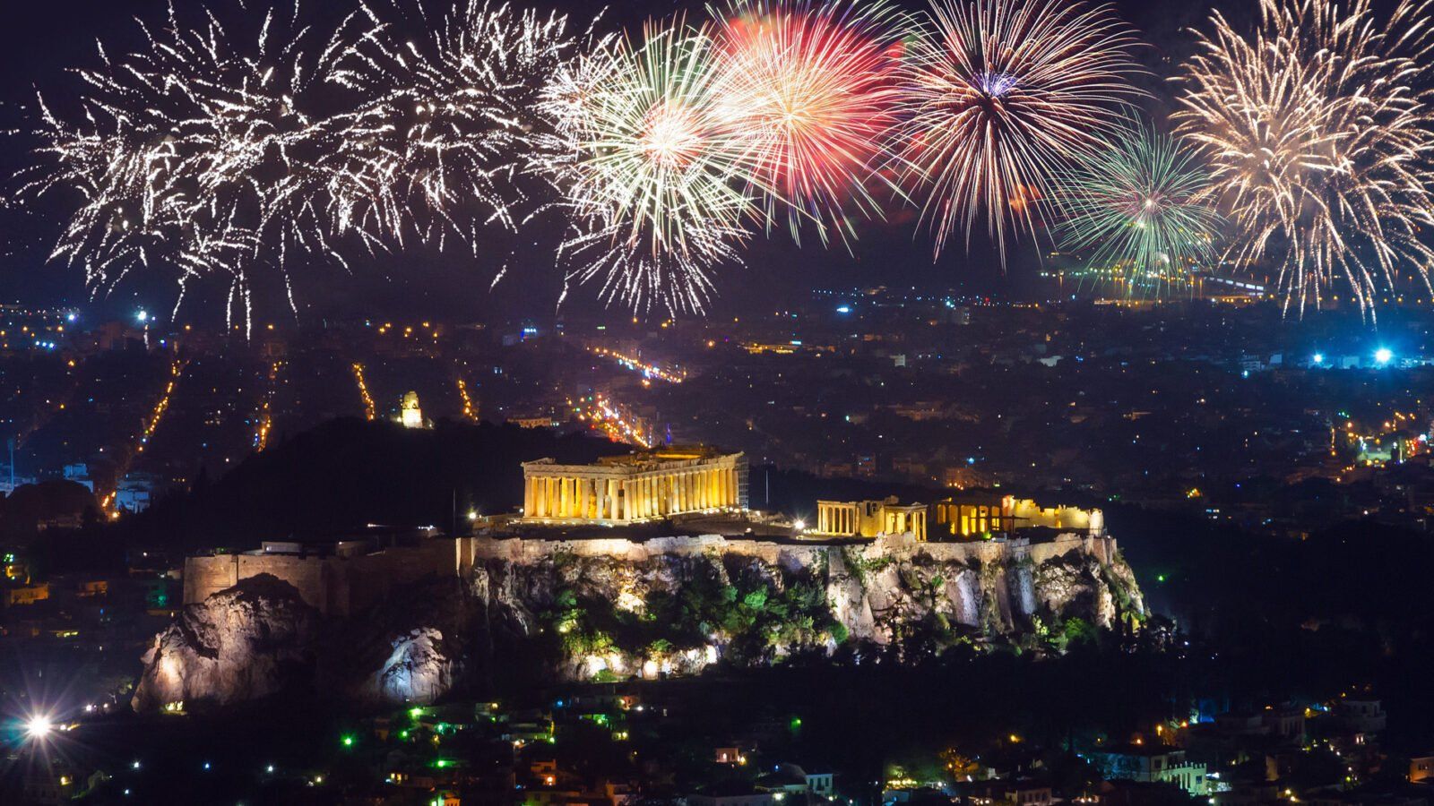 fireworks illuminate the night sky over the Acropolis in Athens, Greece