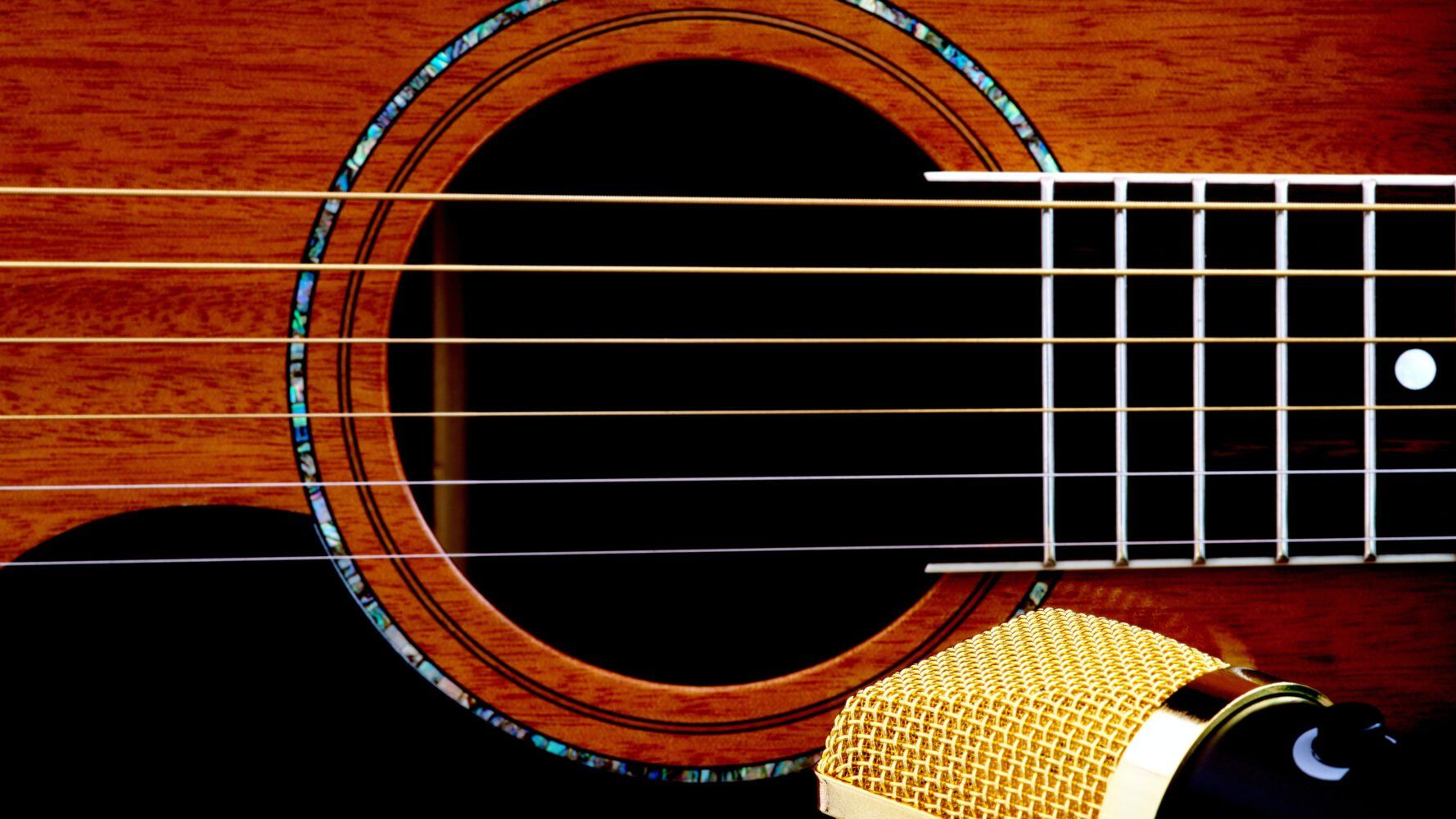closeup of a guitar and a microphone
