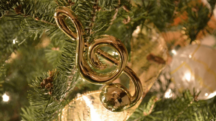 close-up of Golden g-clef Christmas tree ornament on branch