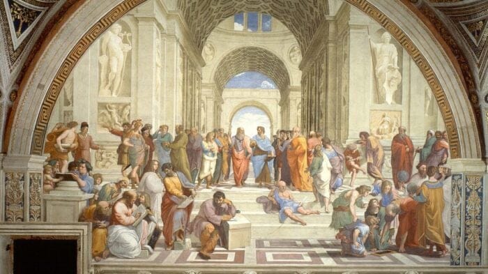 some thirty men, women, and children dressed in garb from Ancient Greece are involved in reading and discourse.