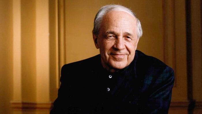 Pierre Boulez smiles in a dark suit