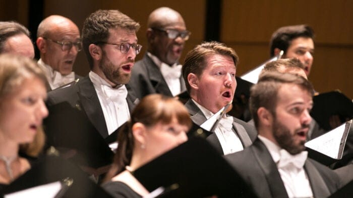 Choral members of Music of the Baroque are in song while onstage
