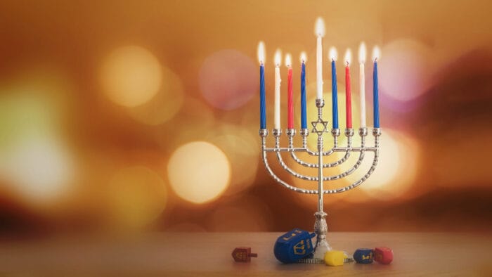 A Hanukkah menorah with dreidels