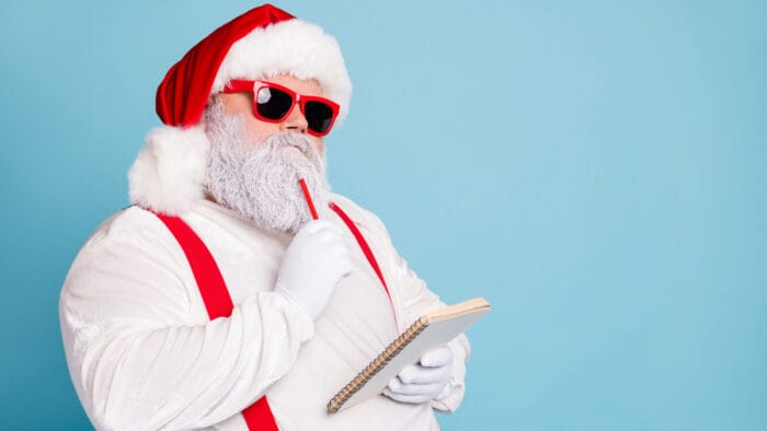 Santa pondering his list in sunglasses