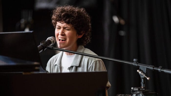 singer with closed eyes at piano