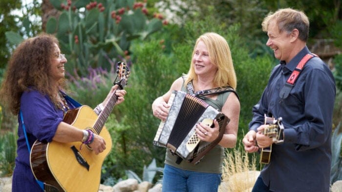 woman with guitar, woman with accordion, man with mandolin