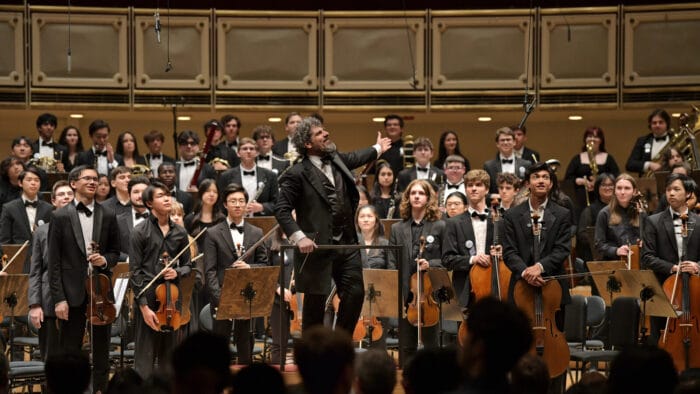 Allen Tinkham and the CYSO SYmphony Orchestra receive the ovation of the audience at Symphony Center