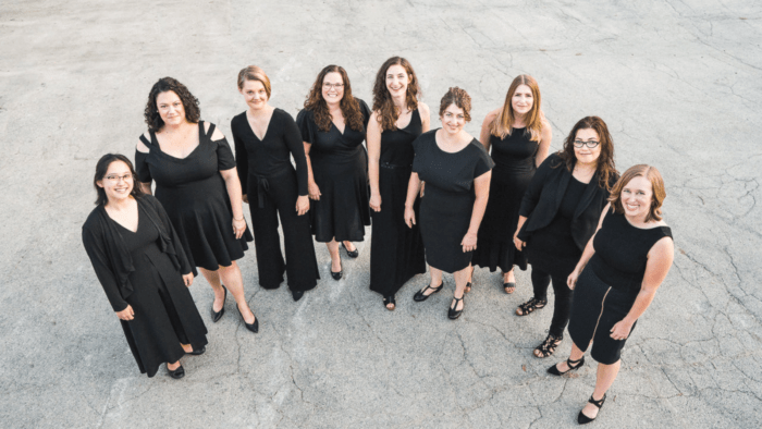 Group photo of La Caccina, a women's vocal ensemble, dressed in black