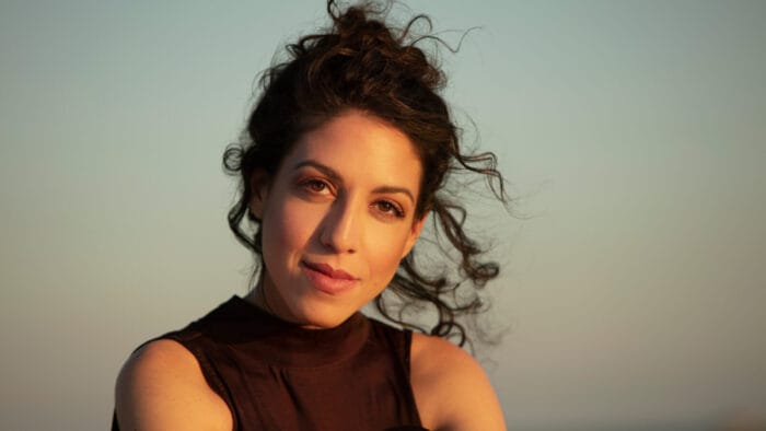 Beatrice Rana smiling against an evening sky backdrop