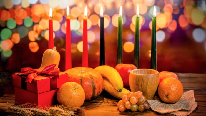 a Kwanzaa kinara with food, decorations, and lights