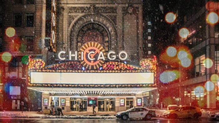 Chicago Theatre marquee in snowfall, out of focus string lights