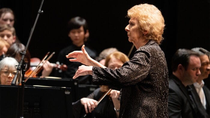 Dame Glover conducting an orchestra