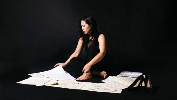 Emiko Edwards studio photo posing with sheet music