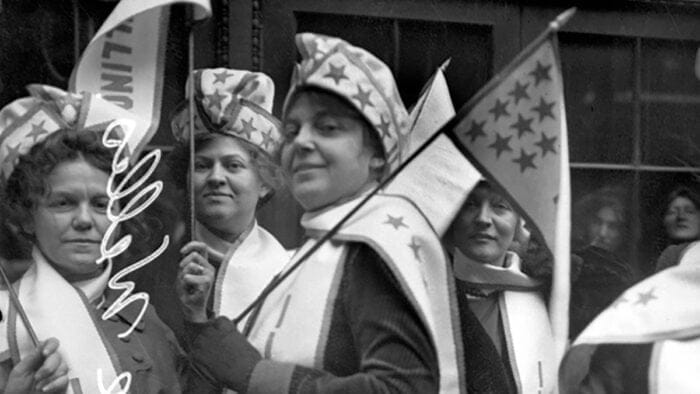 1913 era suffragettes carrying banners