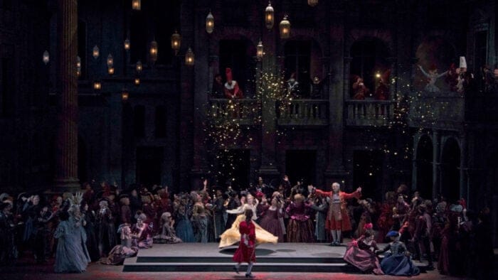 a lively dance scene with period sets and costumes for Gounod's Romeo et Juliette