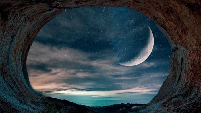a view of the moon looking out from a cave
