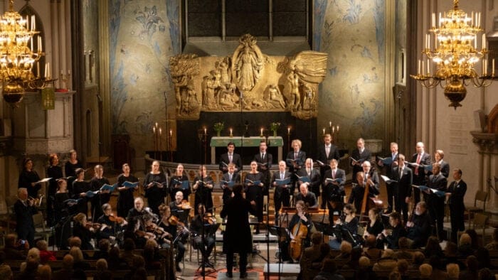 Vocalists and orchestra performing in a church