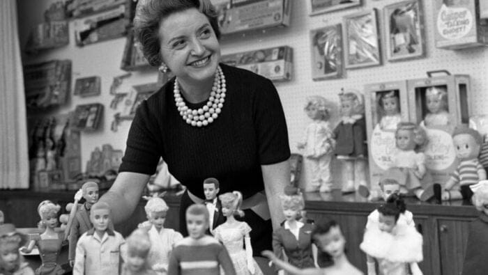 Ruth Handler poses with Barbie dolls