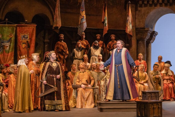 Christian Gerhaher as Wolfram and Andreas Schager as Tannhäuser surrounded by members of the chorus in Wartburg Castle, 13th century costume.