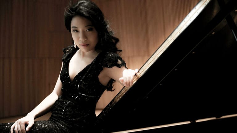 Joyce Yang poses dramatically with the piano