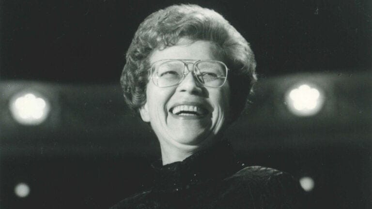 black and white photo of Margaret Hillis smiling onstage at Symphony Center