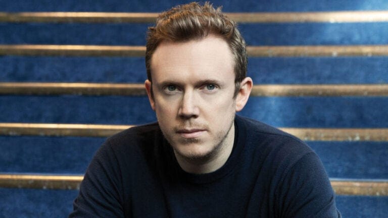 Daniel Harding seated on a stairwell