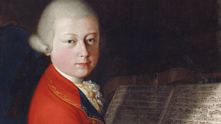 Portrait of Wolfgang Amadeus Mozart aged 13, in white wig, looking over his right shoulder, wearing red coat; music manuscript and string instrument in background.