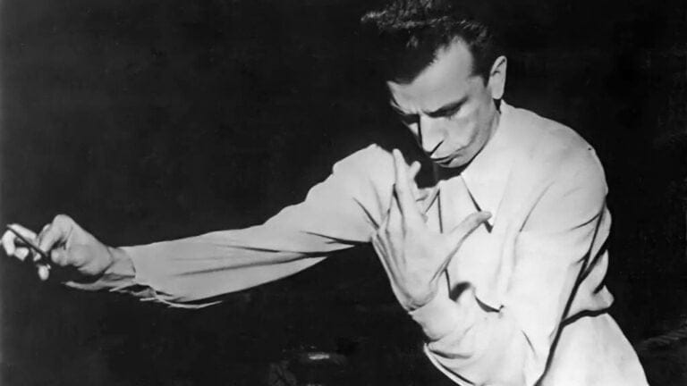 Guido Cantelli bows his head midway through an intense conducting gesture