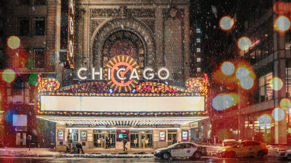 Chicago Theatre marquee in snowfall, out of focus string lights