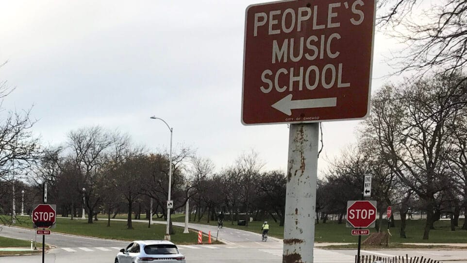 A street sign pointing towards The People's Music School