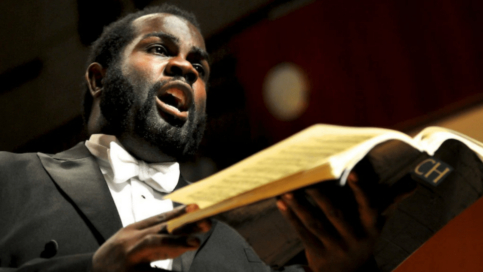 Reginald Mobley holding blue Baerenreiter Bach score