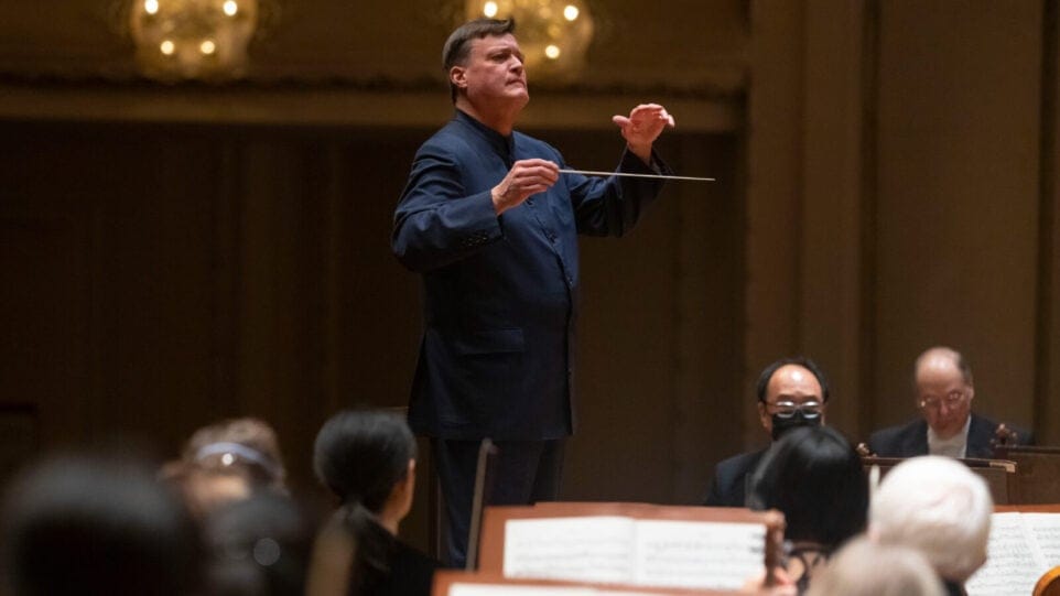 Christian Thielemann gestures towards the orchestra while conducting the CSO