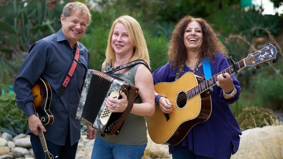 man with guitar, woman with accordion, woman with guitar