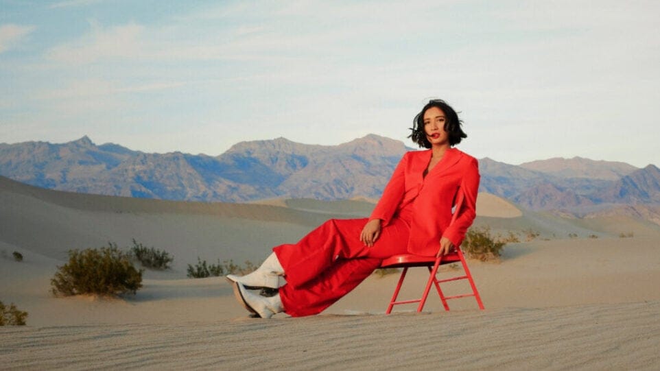 woman in red in a chair in the desert