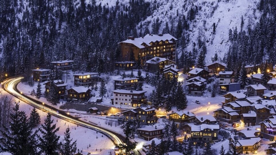 a picturesque, snowy French village at twilight
