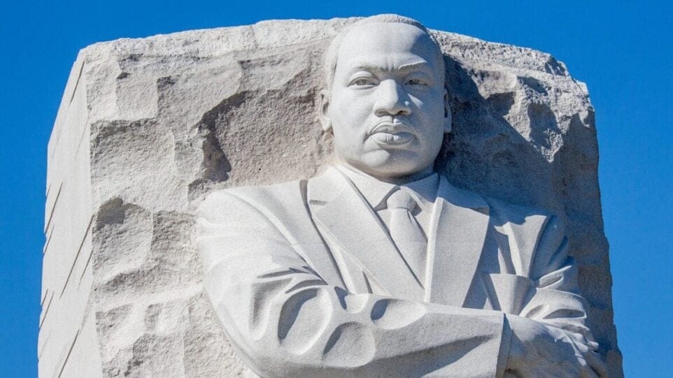 stone sculpture of Martin Luther King Jr. with arms crossed over his chest