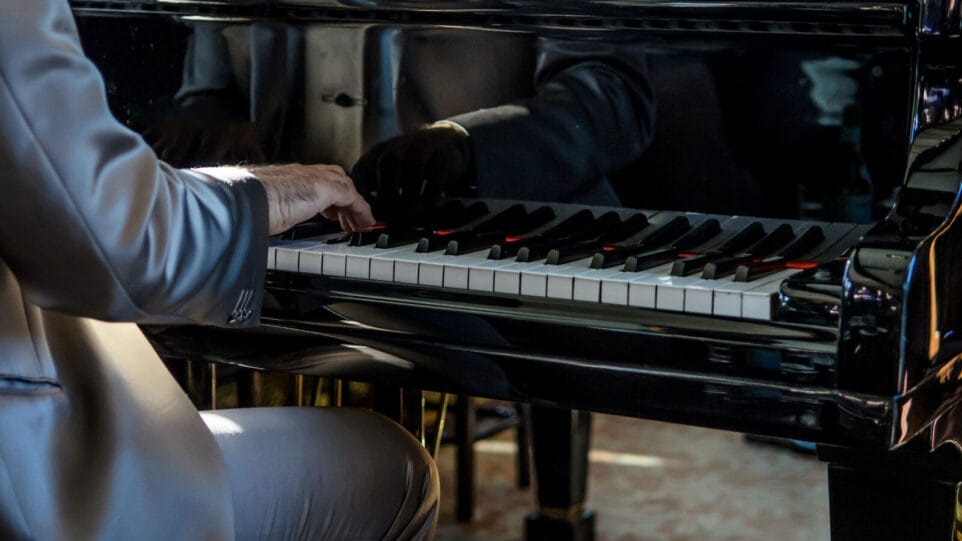 Pianist playing the piano in a nice suit