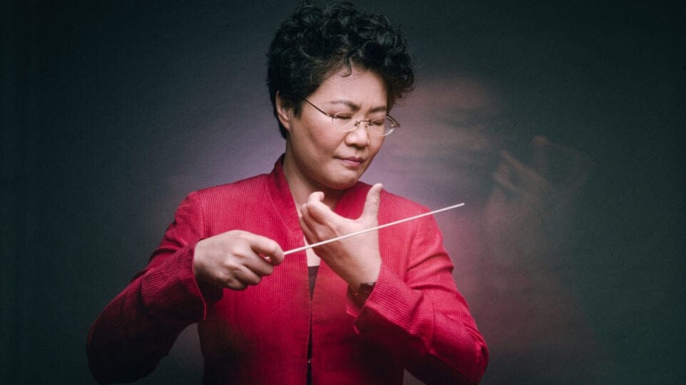 Mei-Ann Chen in action — the conductor's motion is both sharp and blurry in an evocative portrait
