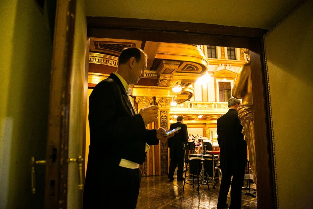 CSO Trombone Michael Mulcahy gives his email a quick check before heading out for the evening’s performance during a 2014 tour. | © Todd Rosenberg Photography