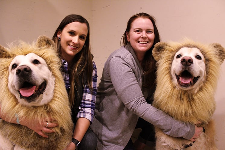 Kelsey Lamm and Morgan (left) and Cassandra Dixon and Louie (right) relax in a backstage dressing room just after the canine stars have gotten into costume