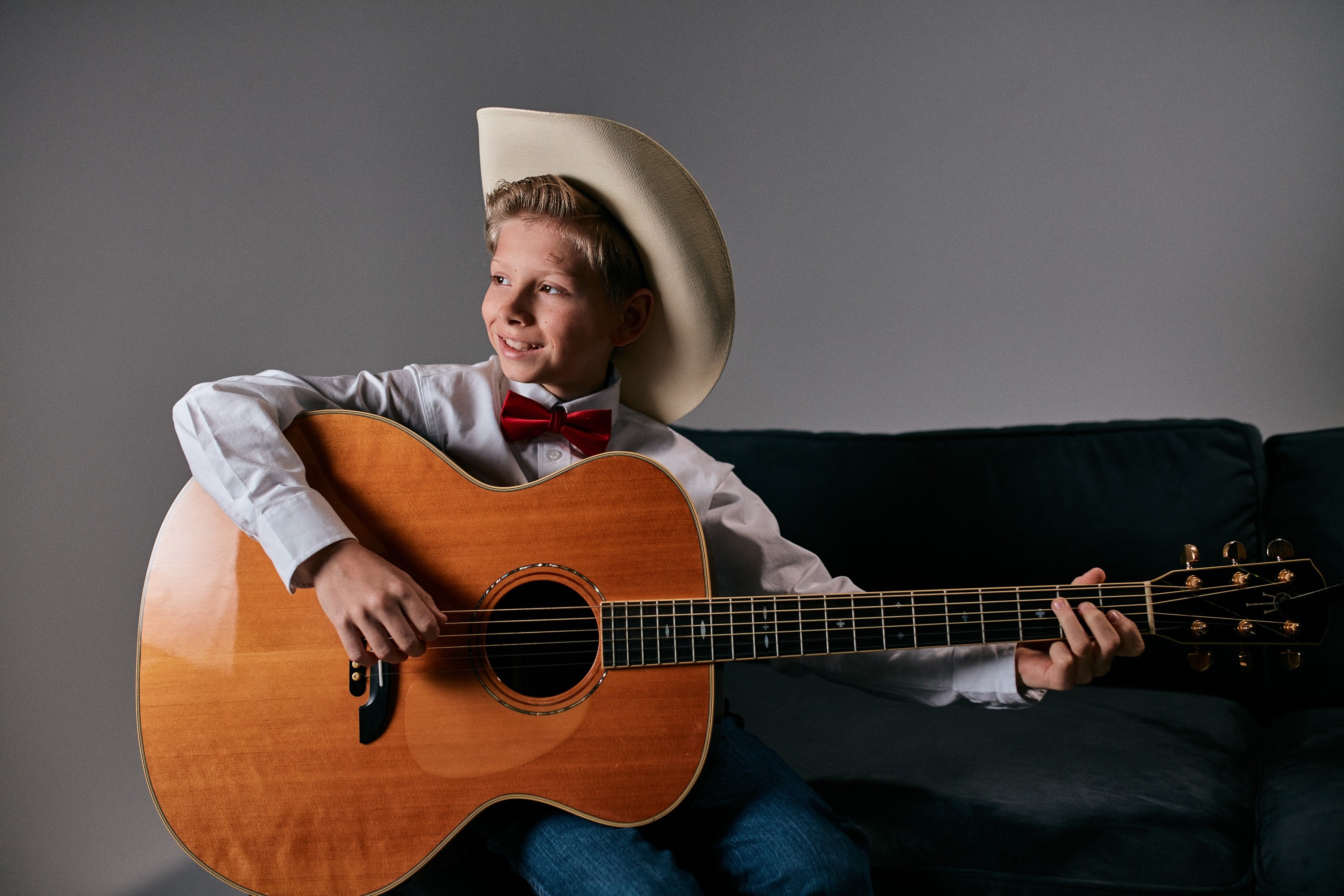 Color photo of Mason Ramsey viral yodeling sensation with guitar