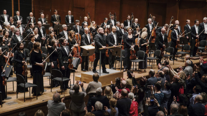 Microphones hang above as Jaap van Zweden conducts the New York Philharmonic with Cynthia Phelps (Photo: Chris Lee)