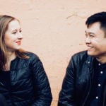Two young musicians smiling at each other