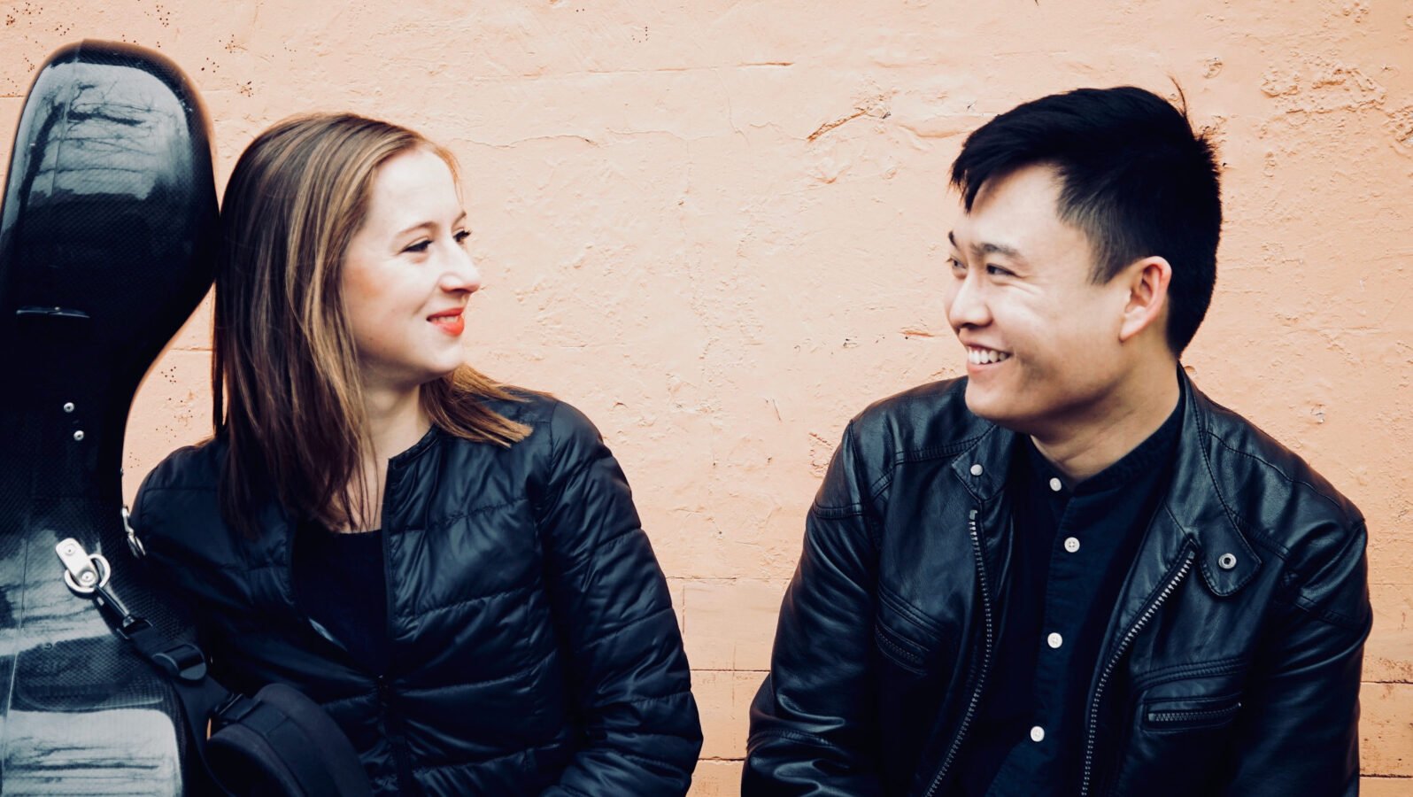 Two young musicians smiling at each other