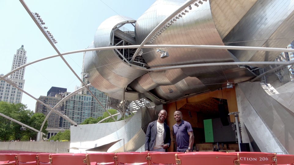 the mcgill brothers pose in front of the strikingly modern pritzker pavilion in millennium park