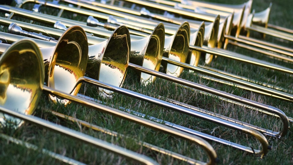 line of trombones in the grass
